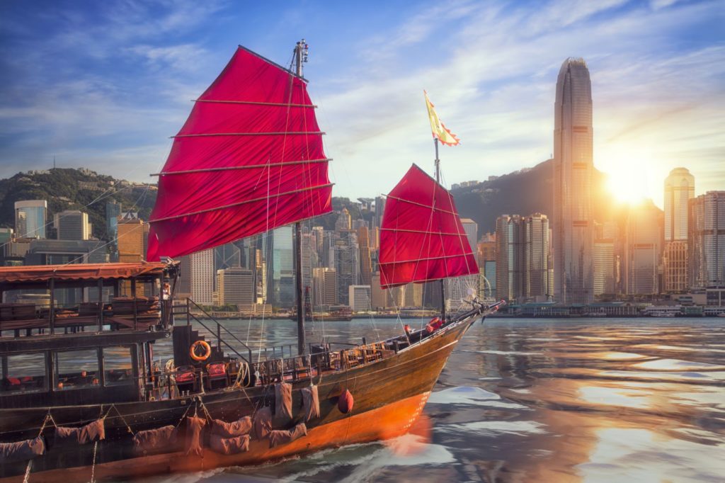 Things to do in Hong Kong, boat at victoria harbour with city skyline in the back