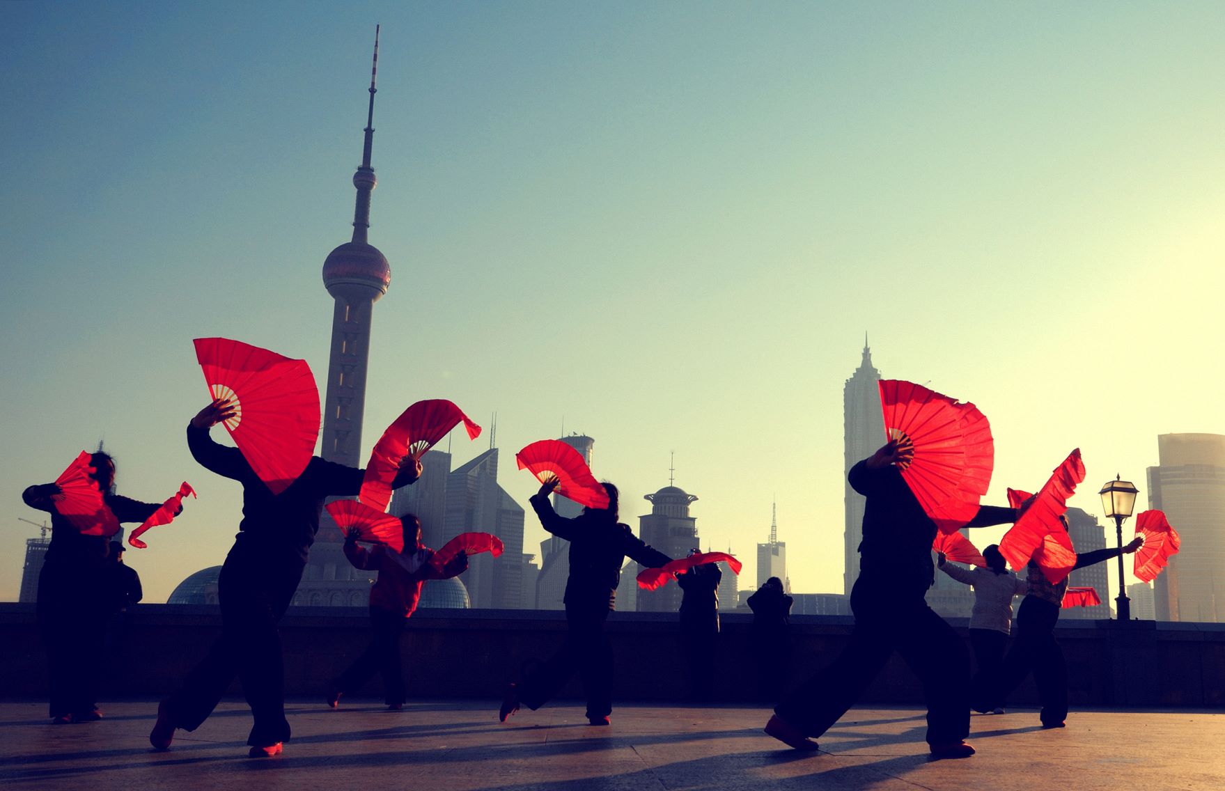 Traditional Chinese dance with red fans in the Bund Shanghai